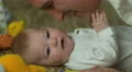 The baby lies on the bed and play with father . Close-up portrait view 4k or 4k+ Resolution