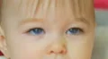 The baby lies on the bed look and smile. Close-up portrait view 4k or 4k+ Resolution