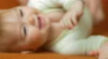 The baby lies on the bed look and smile. Close-up portrait view 4k or 4k+ Resolution