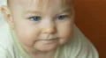 The baby lies on the bed look and smile. Close-up portrait view 4k or 4k+ Resolution