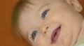 The baby lies on the bed look and smile. Close-up portrait view 4k or 4k+ Resolution