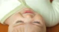 The baby lies on the bed look and smile. Close-up portrait view 4k or 4k+ Resolution