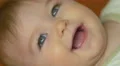 The baby lies on the bed look and smile. Close-up portrait view 4k or 4k+ Resolution