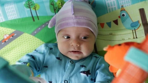 The baby lies on the developing rug Stock Footage 112500576