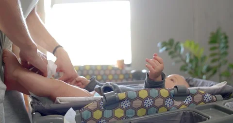 Baby looking at mum while getting changed Stock Footage 112973738