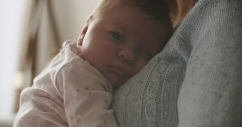 Baby Looking While Mom Holds Her in Morning/Evening Light Stock Footage 122137826