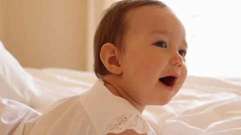 Baby lying on bed Stock Footage 43617352