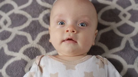 The baby is lying on the bed Stock Footage 106194802