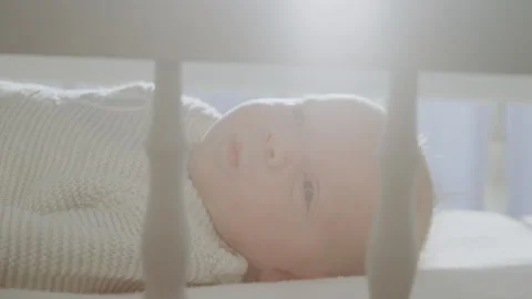 Baby lying in the cradle 스톡 동영상 234331759