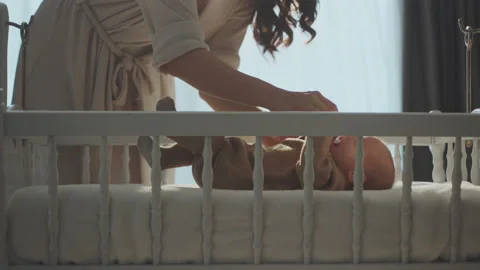 Baby lying in the crib with pacifier 스톡 동영상 234338084