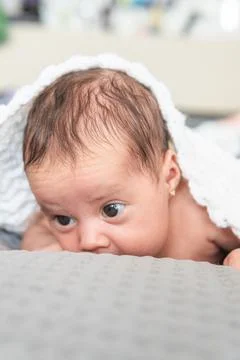 Baby lying face down warm with a white blanket Stock Photos