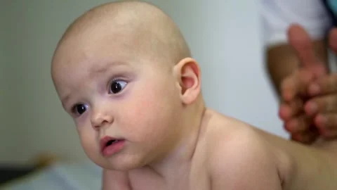 A baby is lying on its back with its head turned to the side Stock-Footage 319416234