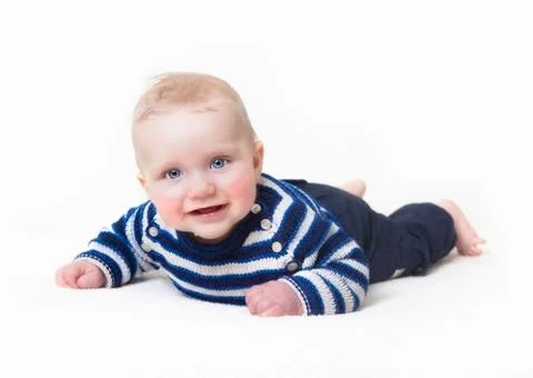 Baby lying looking at camera Stock Photos