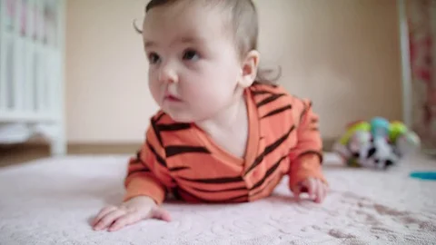 Baby makes an effort to get up Stock Footage 83611260