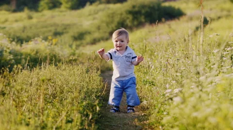 Baby makes first steps hesitantly. Stock Footage 64883089