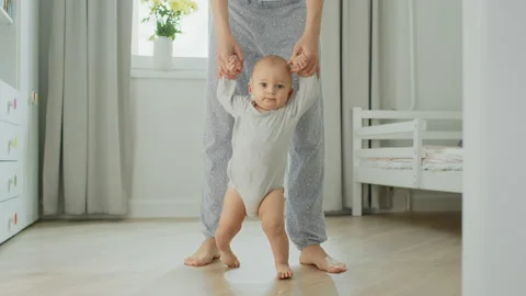 A baby makes his first steps Stock Footage 143352189