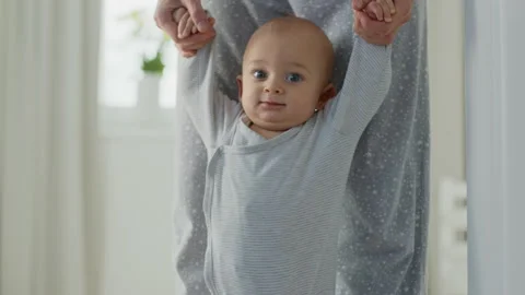 A baby makes his first steps Stock Footage 143352263