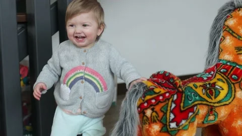 Baby making first steps. Kid learning how to walk Stock Footage 147660499
