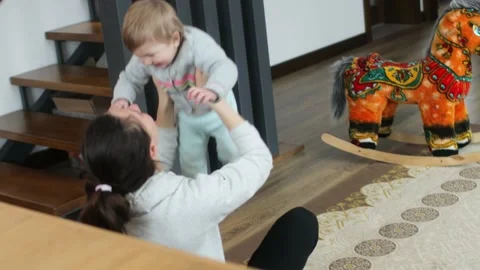 Baby making first steps. Kid learning how to walk Stock Footage 147660601