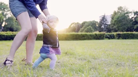 A baby is making the first steps, slow motion Stock Footage 77634624