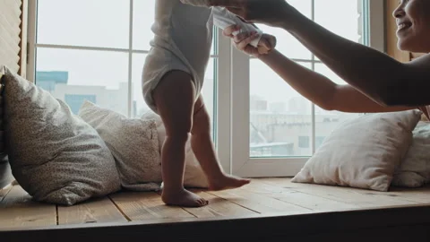 Baby Making First Steps on Window Sill Vídeos de archivo 241003181