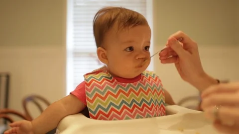 Baby Making Funny Faces When Trying New Food Stock Footage 91299938