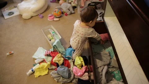 Baby Making a Huge Mess Pulling Clothes Out of Drawer Stock Footage 93993114