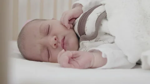 Baby making pain face expression during the sleep Stock Footage 167682804