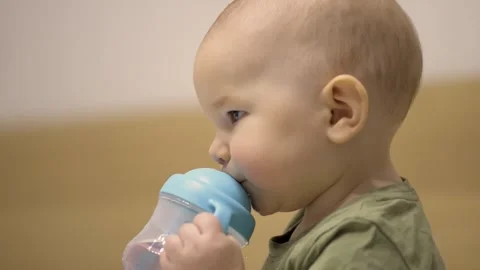 Baby mastering sippy cup Stock Footage 313187155