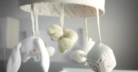 Baby mobile with different animals hanging over the child crib of a newborn Stock Footage 167577140