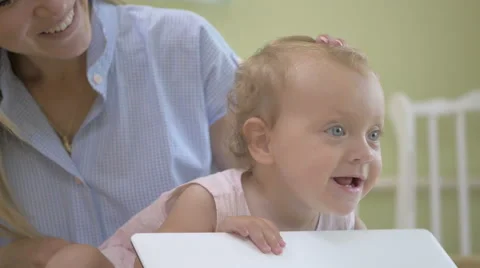 Baby moves lid of the laptop. Stock Footage