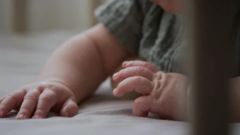 Baby Moving Tiny Hands on Soft Mattress in Crib at Home Vídeos de archivo 346596174