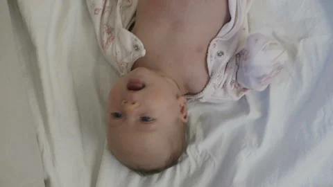 Baby in nappy is lying on sofa Video stock 85519020