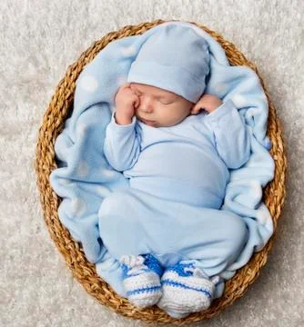 Baby Newborn Sleep in Basket, New Born Child Sleeping in Blue Bodysuit Stock Photos
