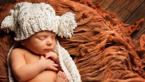 Baby Newborn Sleep in Knitted Hat, New Born Child Sleeping on Brown Blanket Stock Photos