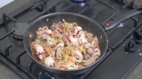 Baby octopus and fried vegetables cooking in pan Stock Footage 113010997