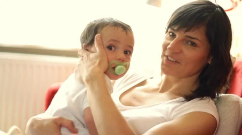 Baby with pacifier in mother arms Stock Footage