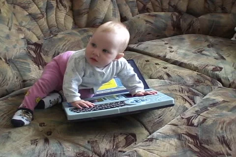 Baby play with computer  動画素材 1077104