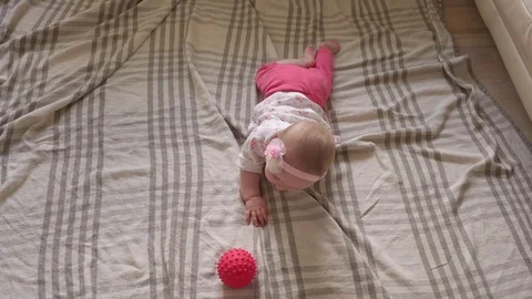 Baby playing and learning to crawl on floor at home Stock Footage 116157749