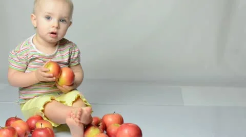 Baby playing with apples Stock Footage 22009889