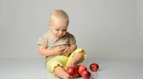 Baby playing with apples Stock Footage 22009914
