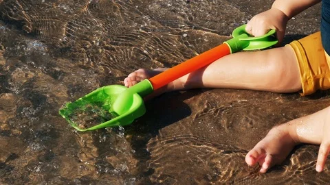 A baby playing on the beach Video stock 123385890