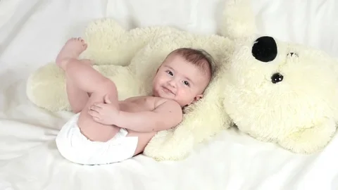 The baby is playing with bear Stockbeeldmateriaal 70602992