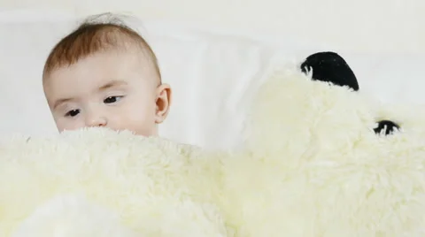 The baby is playing with bear in yellow Video stock 63494860