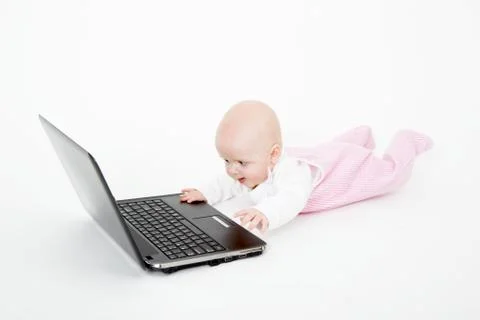 Baby playing on the computer Stock Photos