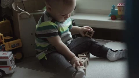 A Baby is Playing with a  cubes. He is exploring the world Stock Footage 147032278