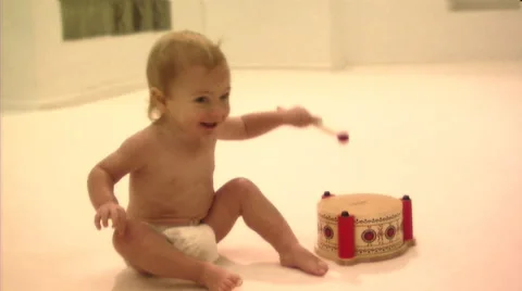 Baby playing with drum Stock Footage 43694979