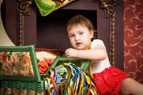 Baby playing fireplace with thread Stock Photos