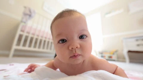 Baby Playing on Floor Looking at Camera, Close Up Stock Footage 91143557