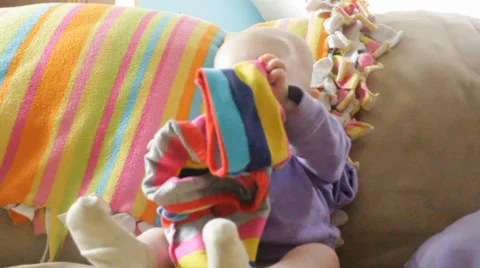 Baby playing with her pants Stock Footage 35800755